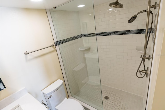 bathroom featuring toilet and tiled shower