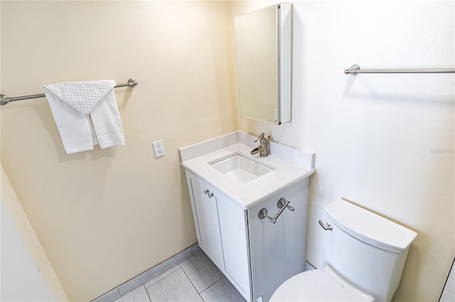 bathroom with tile patterned flooring, vanity, and toilet