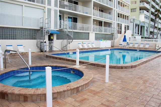 view of swimming pool with a community hot tub