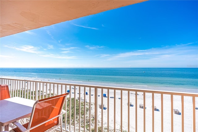 balcony with a water view and a beach view