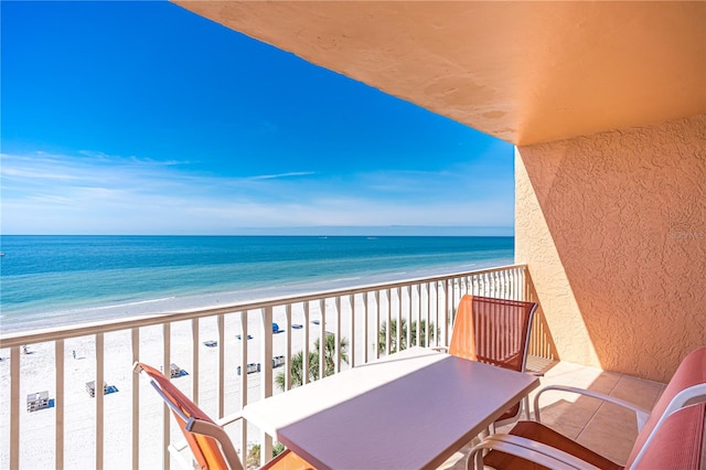 balcony featuring a water view and a view of the beach