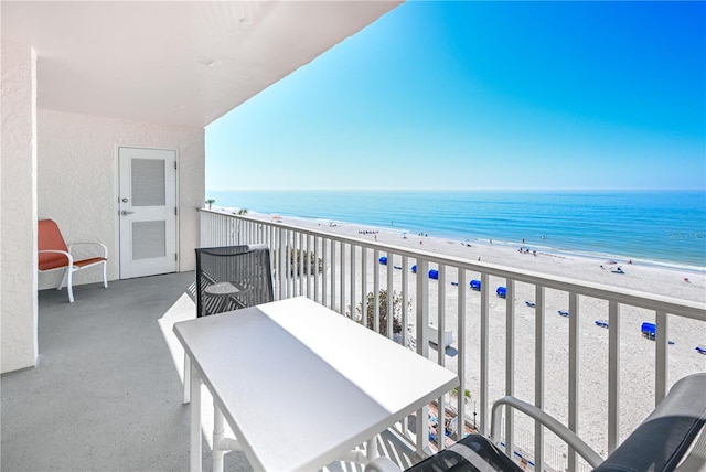 balcony featuring a water view and a view of the beach