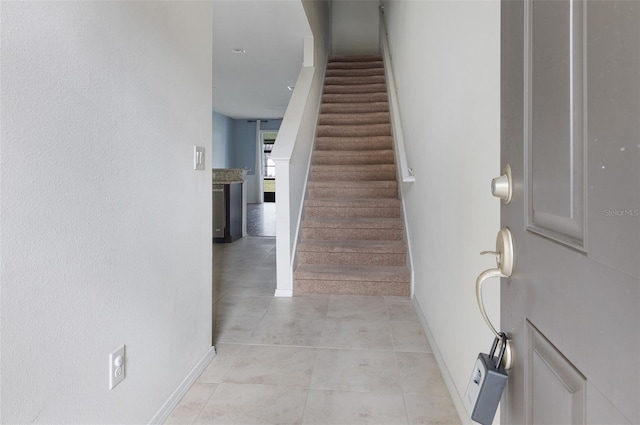 stairway with tile patterned floors