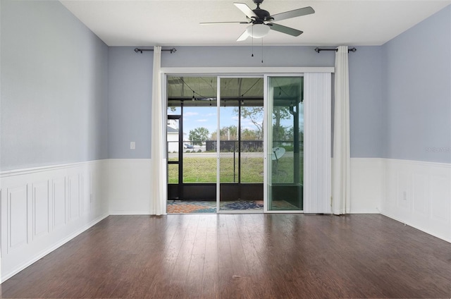 unfurnished room featuring dark wood-type flooring and ceiling fan