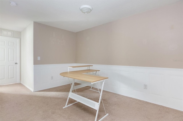 unfurnished dining area featuring light colored carpet