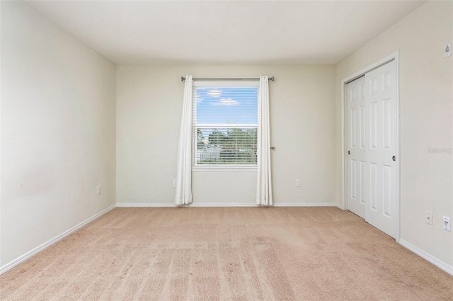 spare room with light colored carpet