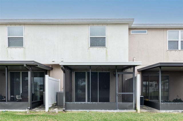 back of property featuring a sunroom and central air condition unit