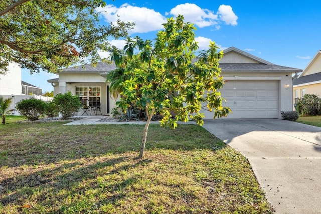 view of front of home with a front lawn and a garage