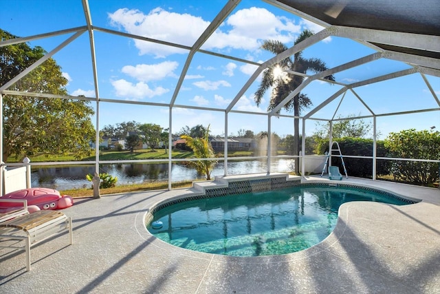 view of pool featuring a patio, a water view, and glass enclosure