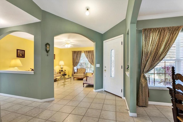 tiled entryway with vaulted ceiling and ceiling fan