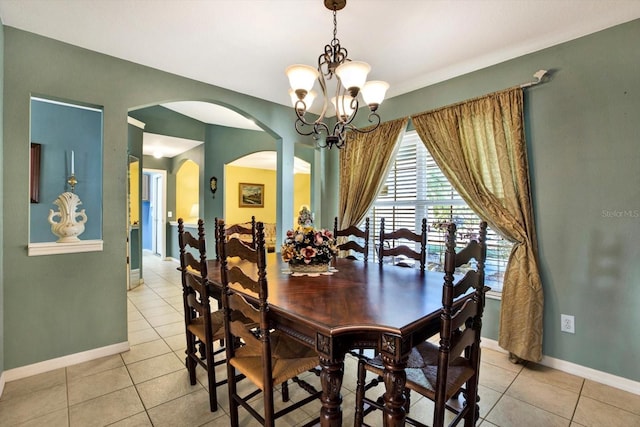 tiled dining area featuring a chandelier