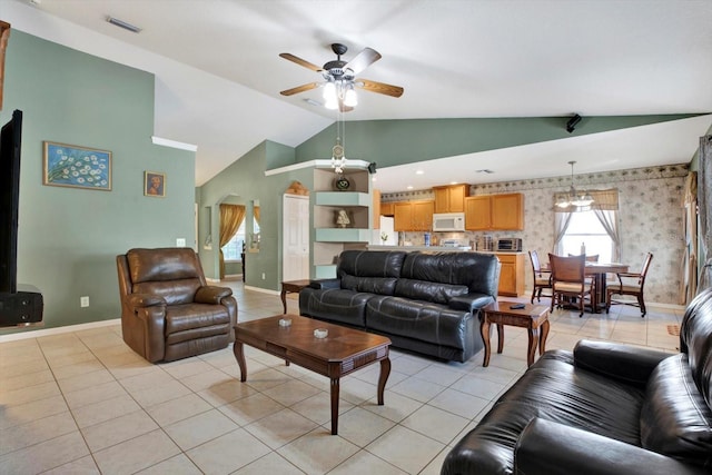 tiled living room featuring ceiling fan and vaulted ceiling