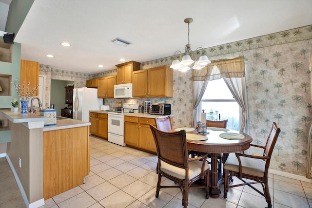 kitchen featuring light tile patterned floors, decorative light fixtures, white appliances, and an inviting chandelier