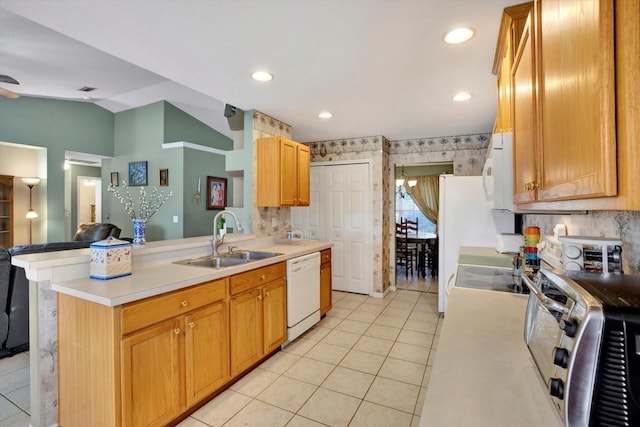 kitchen with kitchen peninsula, sink, light tile patterned floors, and white appliances