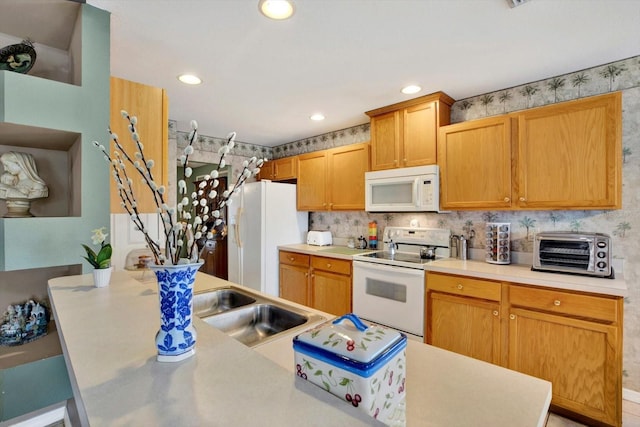 kitchen featuring white appliances and sink