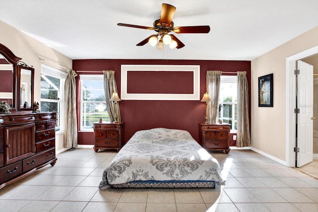 tiled bedroom with multiple windows and ceiling fan