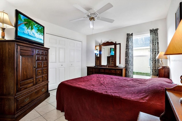 tiled bedroom with a closet and ceiling fan