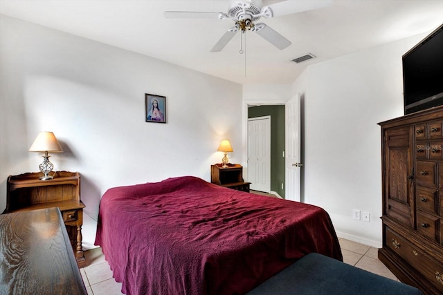 bedroom with ceiling fan and light tile patterned floors