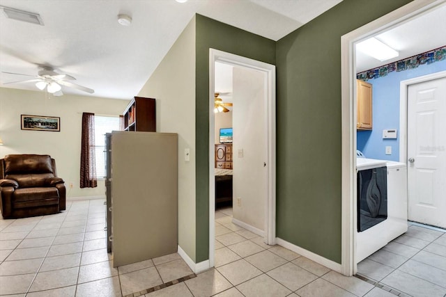 hall with light tile patterned floors and washer / clothes dryer