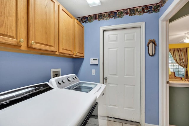 laundry room with cabinets, washing machine and dryer, ceiling fan, and tile patterned flooring