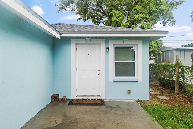 view of exterior entry featuring a patio