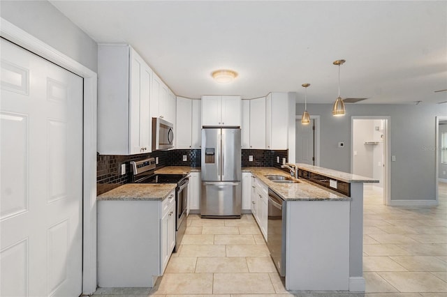 kitchen featuring light stone countertops, stainless steel appliances, kitchen peninsula, decorative light fixtures, and white cabinets