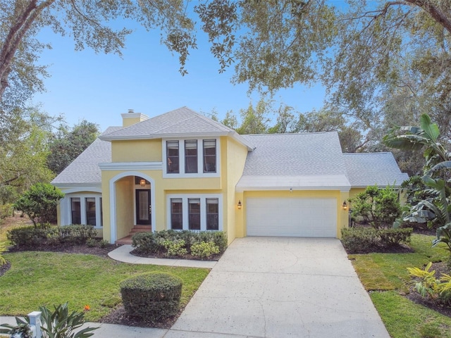 view of front of property with a front yard and a garage