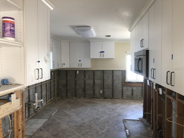 kitchen with white cabinetry and ornamental molding