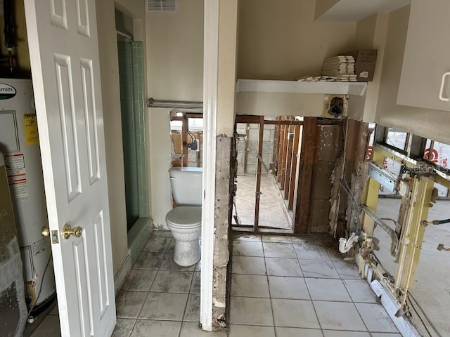 bathroom featuring tile patterned flooring, water heater, visible vents, and toilet