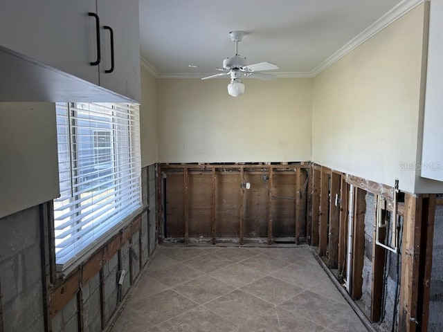 spare room featuring ornamental molding, light tile patterned flooring, and ceiling fan