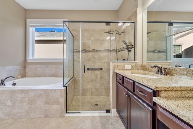 bathroom with tile patterned floors, vanity, and independent shower and bath