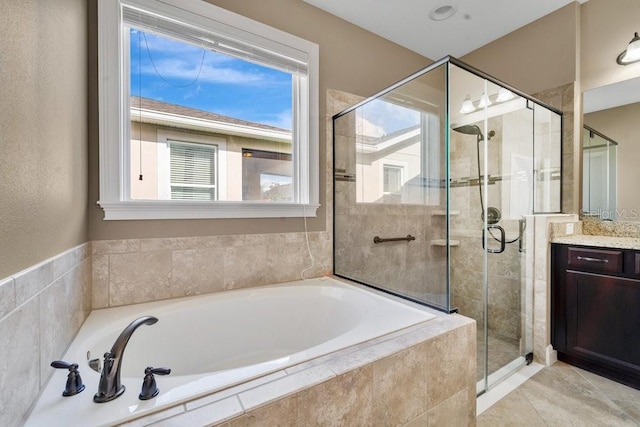 bathroom with vanity and independent shower and bath