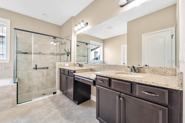 bathroom featuring tile patterned flooring, vanity, and an enclosed shower