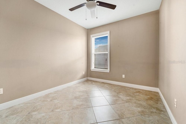 tiled empty room with ceiling fan