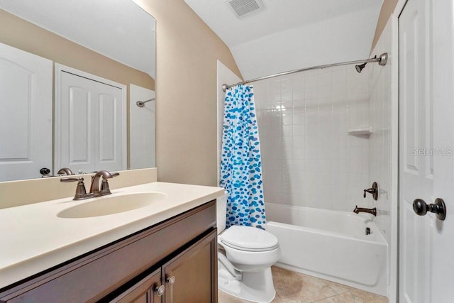 full bathroom featuring tile patterned floors, vanity, shower / bath combo with shower curtain, toilet, and lofted ceiling