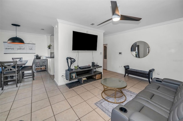 living room featuring crown molding, ceiling fan, and light tile patterned floors