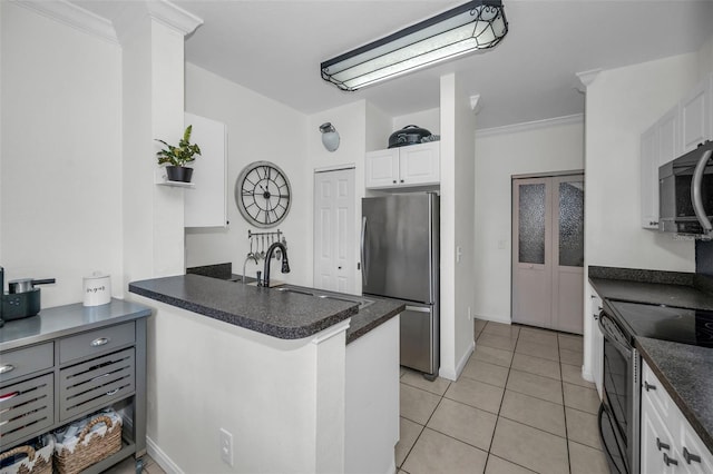 kitchen with kitchen peninsula, black range with electric cooktop, white cabinetry, stainless steel refrigerator, and light tile patterned flooring