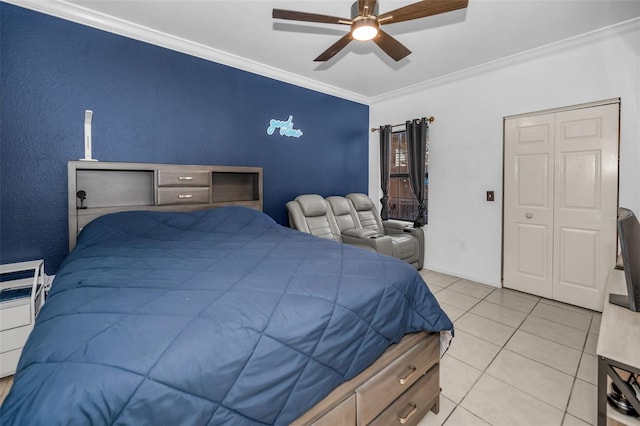 bedroom with ceiling fan, a closet, light tile patterned floors, and ornamental molding