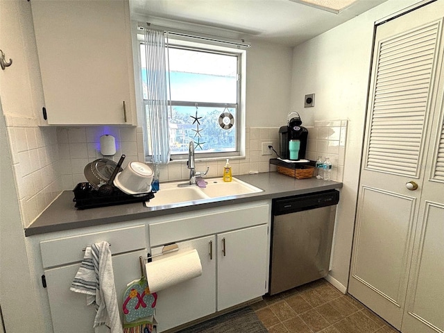 kitchen with dishwasher, white cabinetry, sink, and tasteful backsplash