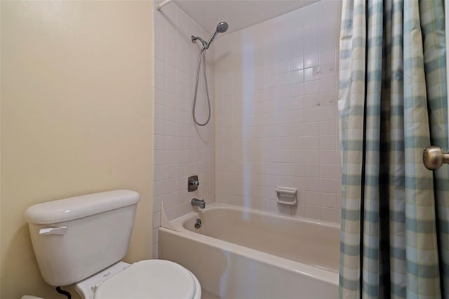 bathroom with shower / bath combination with curtain and toilet