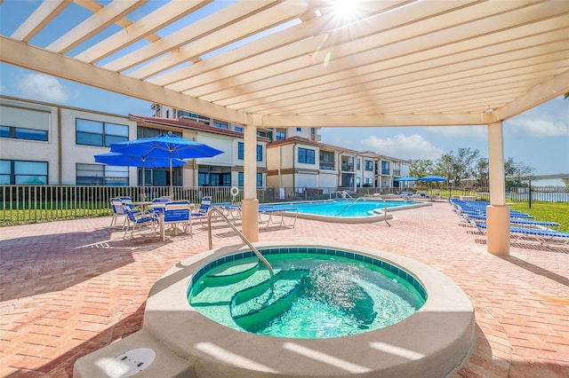 view of swimming pool with a patio, a pergola, and a hot tub