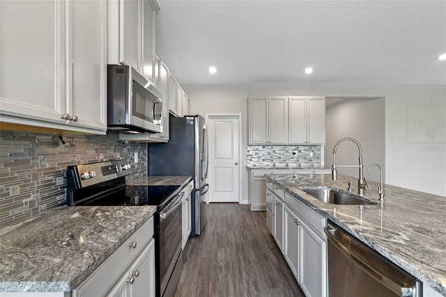 kitchen with white cabinets, dark hardwood / wood-style floors, sink, and stainless steel appliances