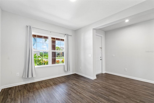 empty room featuring dark hardwood / wood-style flooring