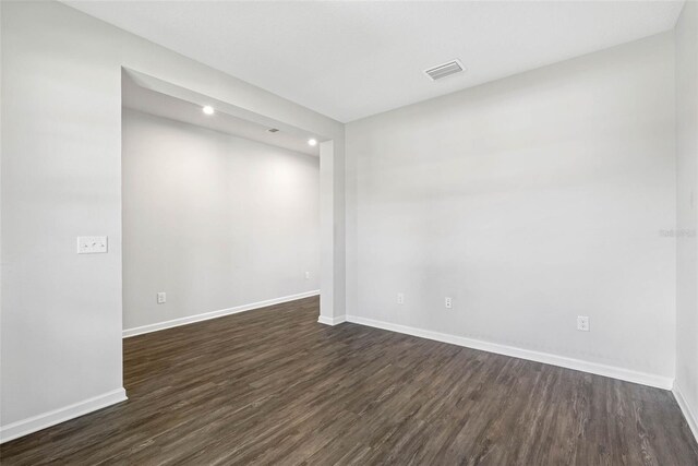 empty room featuring dark hardwood / wood-style flooring