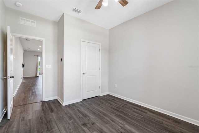 unfurnished bedroom with dark hardwood / wood-style flooring and ceiling fan