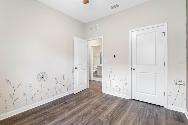 unfurnished bedroom featuring ceiling fan and dark hardwood / wood-style flooring