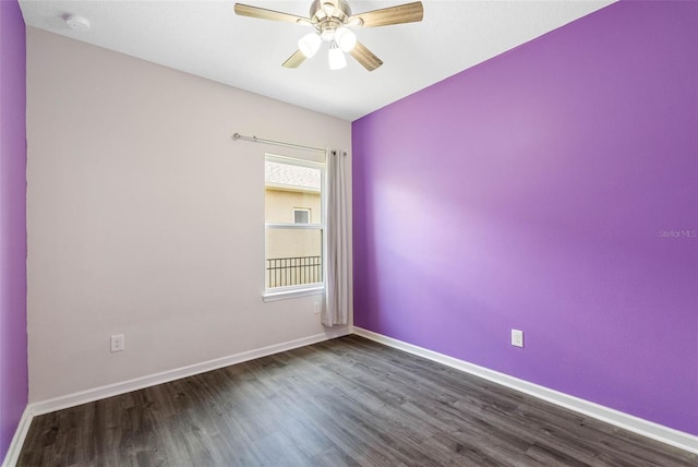 empty room with ceiling fan and dark wood-type flooring