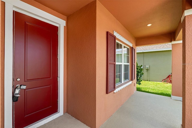 view of exterior entry with covered porch