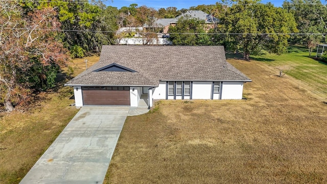 view of front of home with a garage and a front lawn