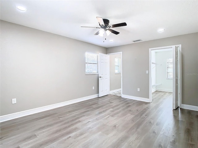 spare room with light hardwood / wood-style flooring and ceiling fan